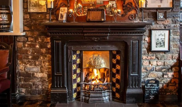 old fashioned fireplace with an open fire in the Brazen Head pub, Dublin