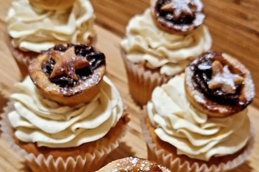 cupcakes with frosting and mince pies sitting on top
