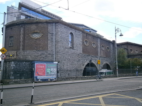 exterior of a grey brick building behind the harcourt luas - used to be tripod