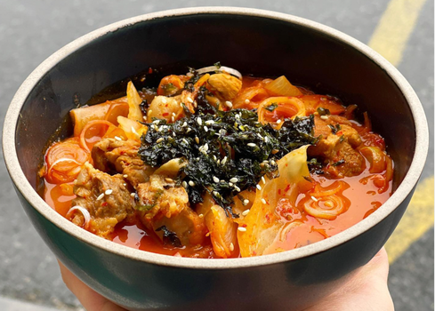 bowl of kimchi stew with seaweed gim and rice