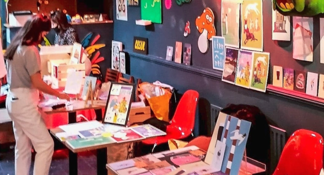 market with colourful prints and vinyls, a woman browsing