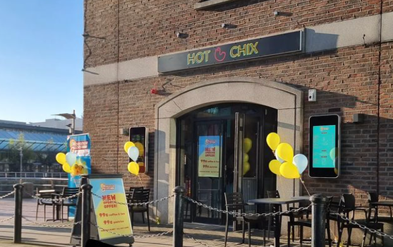 Exterior of Morning Glory Cafe with yellow and blue balloons outside