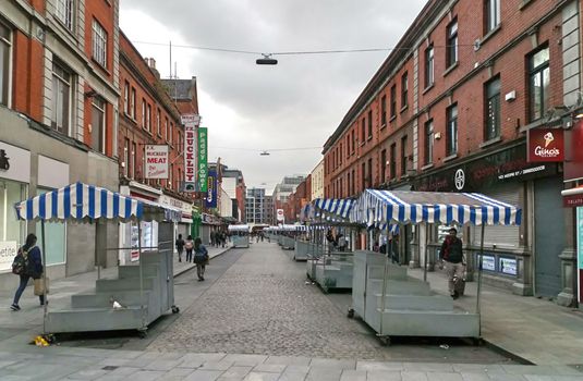 empty stalls with blue and white striped canopies on Moore Street