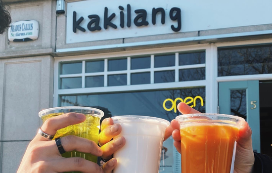 three boba teas being held up outside Kakilang shop front