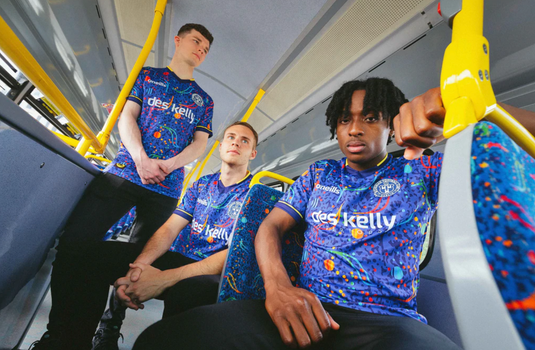 three men on dublin bus wearing bohs jerseys with the dublin bus seat print