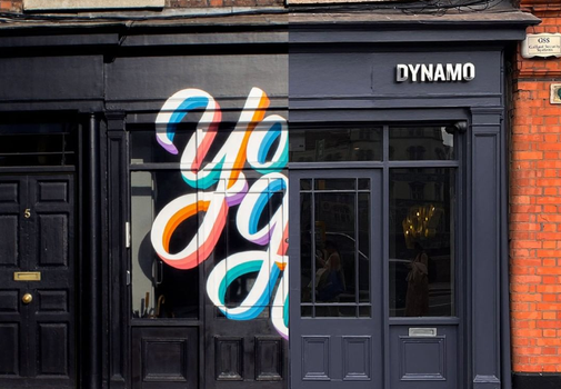 navy shop front with a mural that reads "you got this" half painted over on one side.