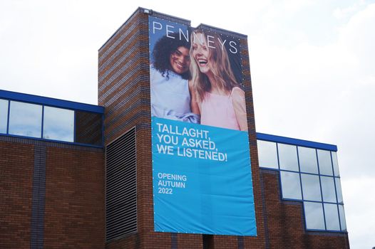 large sign outside the Square Tallaght shopping centre with the penneys logo and two models smiling, which reads "you asked, we listened! Opening Autumn 2022"