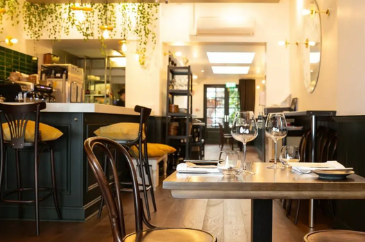 interior of Circa restaurant, with fairy lights, plants hanging from the ceilings and tables and chairs