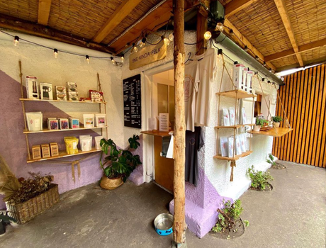 one kinda folk coffee shed, with purple and white coloured walls and shelves filled with coffee equipment