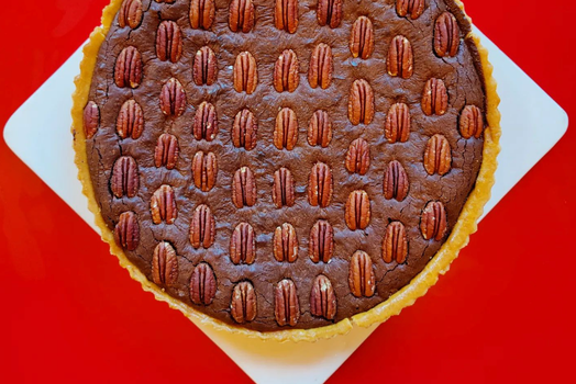 pecan pie on a white and red background