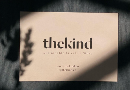 logo for The Kind store on a small sheet of card