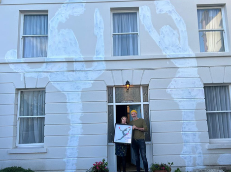 exterior of a period house in sandycove, the outline of a mural which has been painted over is visible