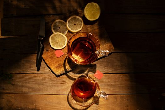 overhead shot of hot whiskey with slices of lemon beside it