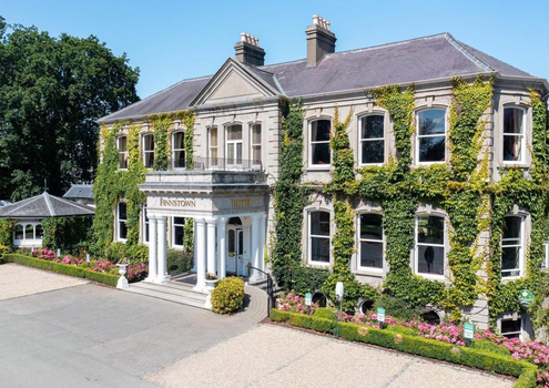 exterior of finnstown hotel, a period style building with ivy on the walls