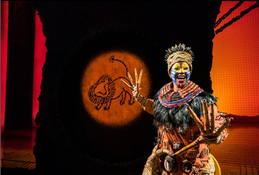 actor on stage during production of lion king