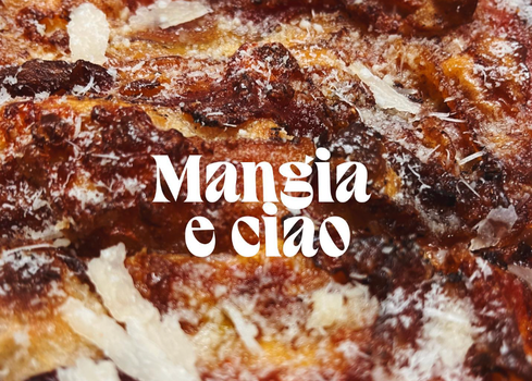 close up of a pizza with the words 'Mangia e Ciao' typed in white font