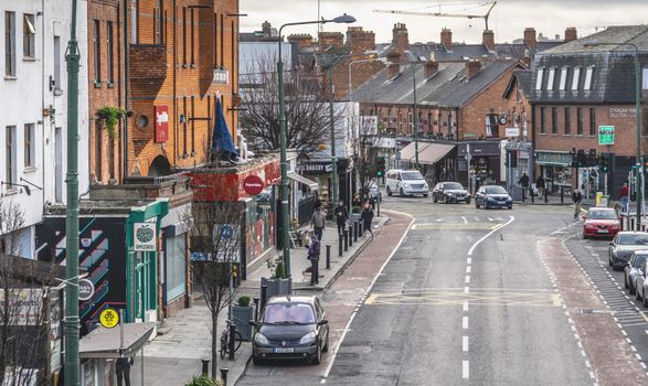 main road through ranelagh village, a car can be seen parked in the cycle lane