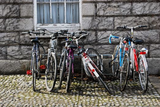 several bikes parked up at a bike rack