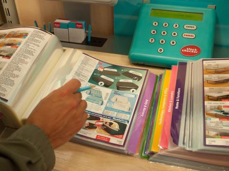 overhead shot of a person flicking through the argos catalogue