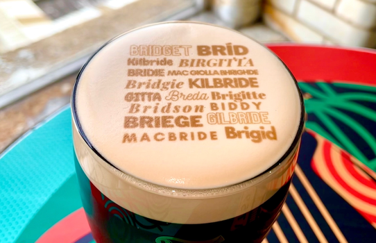 a pint of guinness with the various derivatives of the name Brigid printed on top