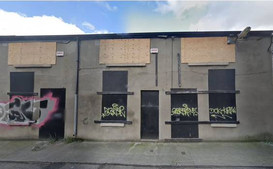 a derelict building with boarded up windows in dublin