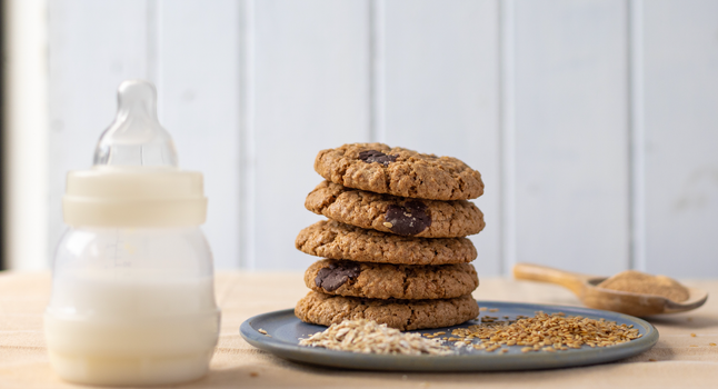 a bottle of breast milk alongside a stack of cookies