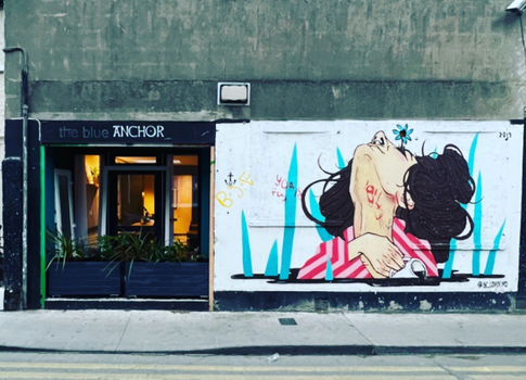 a wall in Dublin's Liberties with a colourful mural of a woman with dark hair