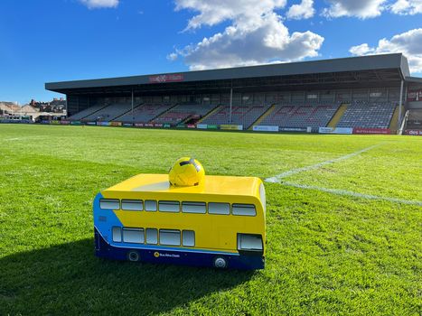 mini dublin bus carrying a ball on the pitch at dalymount park